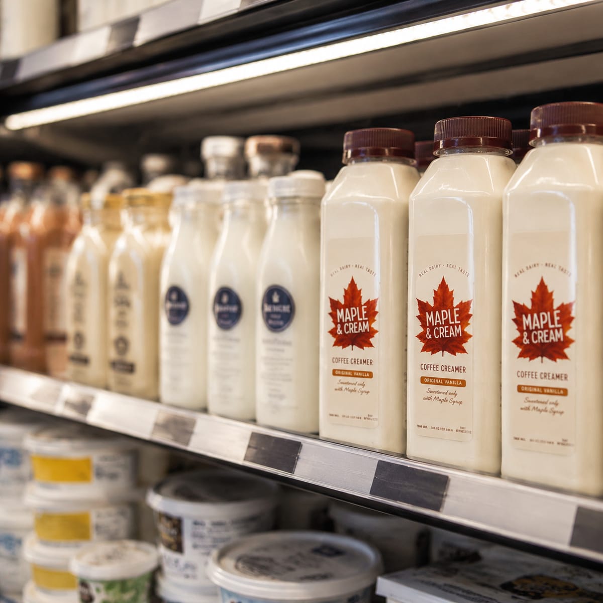Maple & Cream bottles on a café counter